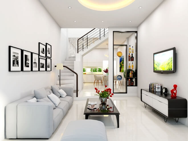 Thiết kế nhà ống, Phòng khách với tông màu trắng sáng sủa. Dàn kệ gỗ màu đen và những bức tranh đen trắng tạo điểm nhấn cho không gian thêm đẹp mắt